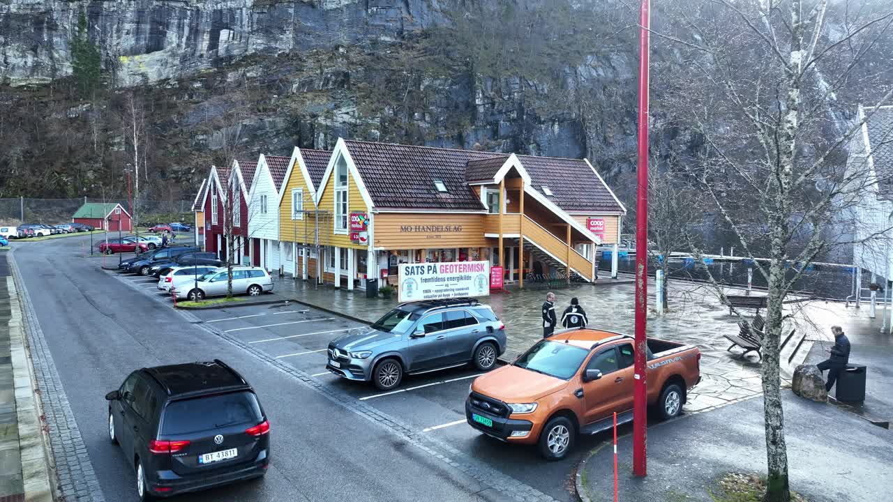 Scenic Norwegian Fjord Village with Colorful Houses and Cars