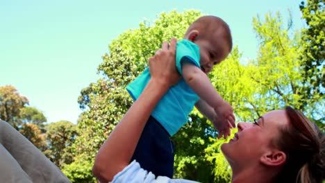 Happy-mother-playing-with-her-cute-baby-son