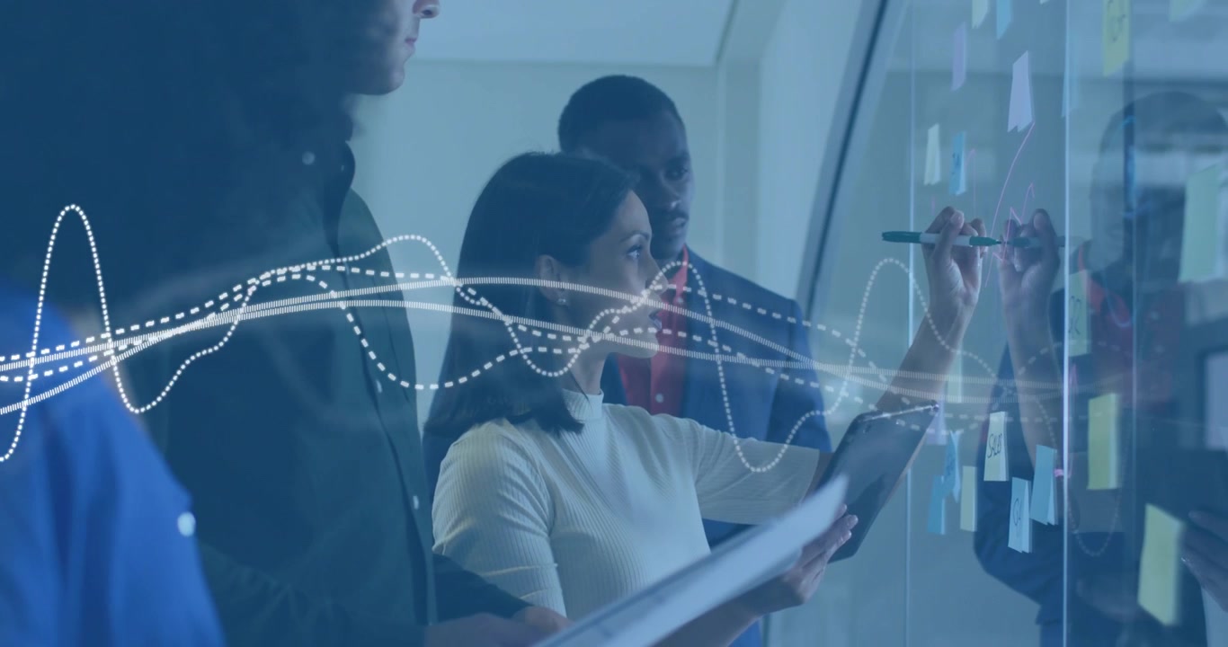 With pulsing waveform on glass wall, business team organizing sticky notes while referencing tablet