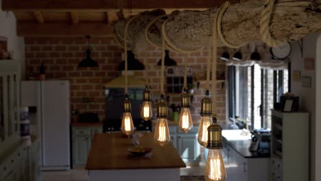 slow revealing shot of rope lights hanging from a log in a villa kitchen