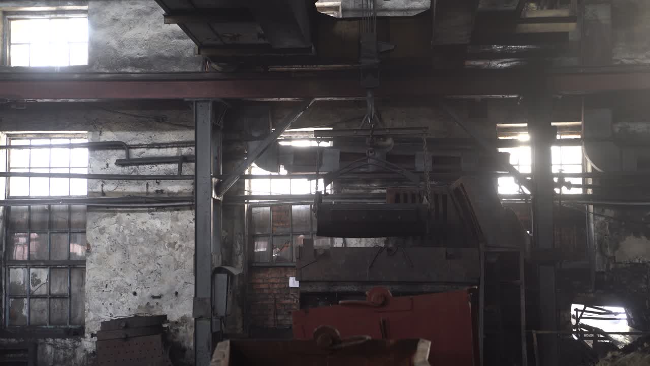 Factory overhead crane inside factory building. Factory room structure made from iron and steel. Old industrial grunge wall with metal structures