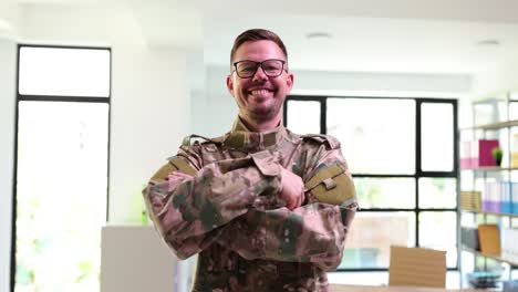 smiling man in military uniform with crossed arms