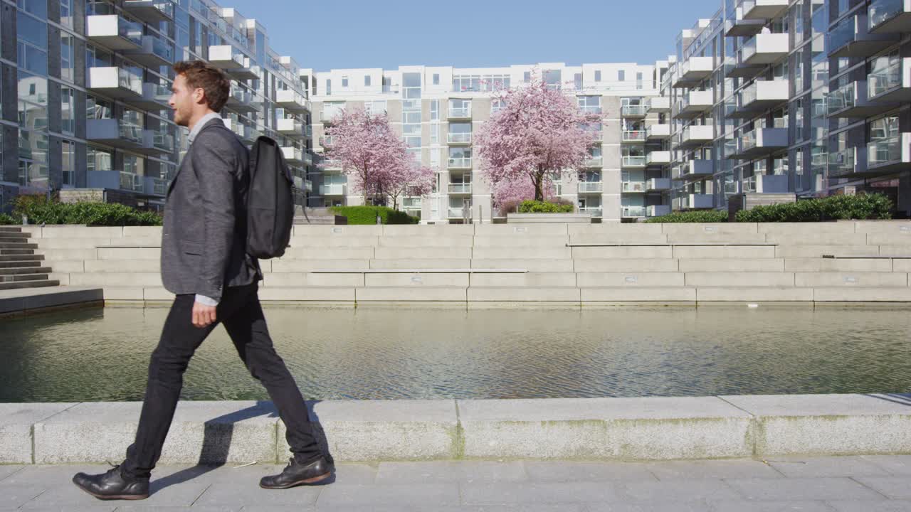 Businessman - Young urban professional business man walking to work