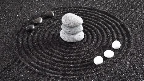 japanese zen garden with yin yang stones in textured sand