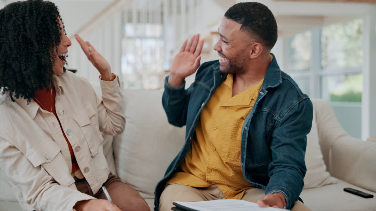 Happy couple embracing and celebrating at home