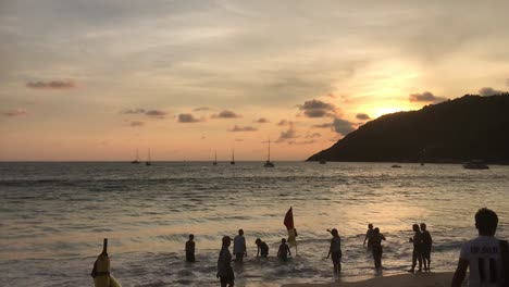 hand held wide shot of sunset at rawai beach, thailand