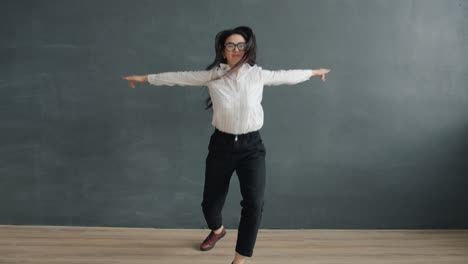 woman dancing in front of a dark wall