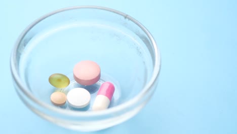 assorted pills in a glass bowl