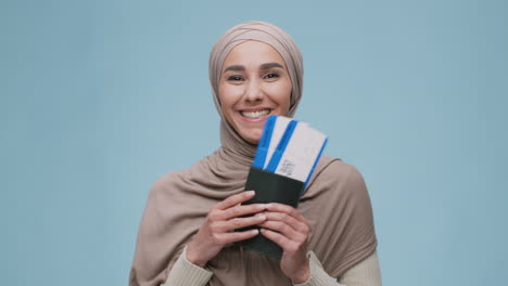 woman holding passport and plane tickets