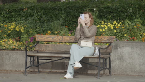 woman taking pictures in a park