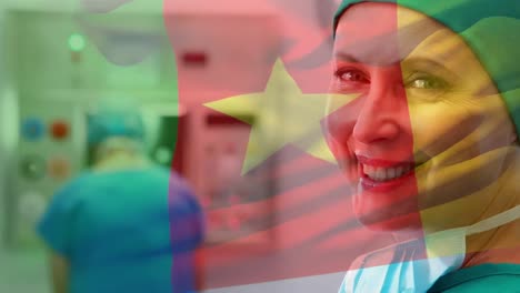 animation of flag of cameroon over caucasian female doctor smiling