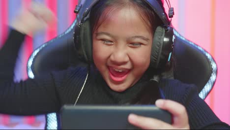 girl playing video games on smartphone