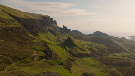 aerial drone footage of the dramatic mountain landscapes on the isle of skye, scotland. sweeping panoramic views of majestic peaks, green valleys, and wild nature