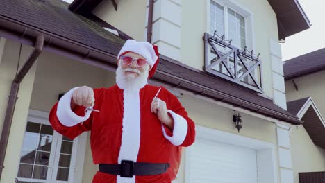 santa claus just bought a new house and show keys on camera