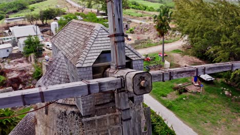 Iconic-windmill-in-lush-landscape,-drone-pull-out.-Barbados