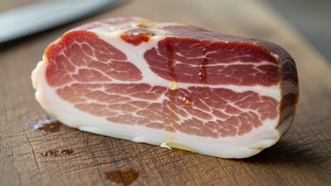 close-up of sliced cured meat on a wooden cutting board with natural juices, showcasing the rich color and texture of high-quality charcuterie
