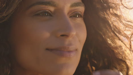 close up portrait of beautiful happy woman enjoying freedom exploring spirituality feeling joy on peaceful beach at sunset with wind blowing hair