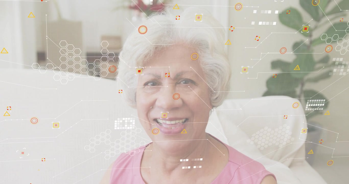 After one second senior woman sitting on sofa smiling as network icons drifting forming tech layer