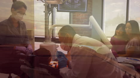 View of sunset against dentist treating patient