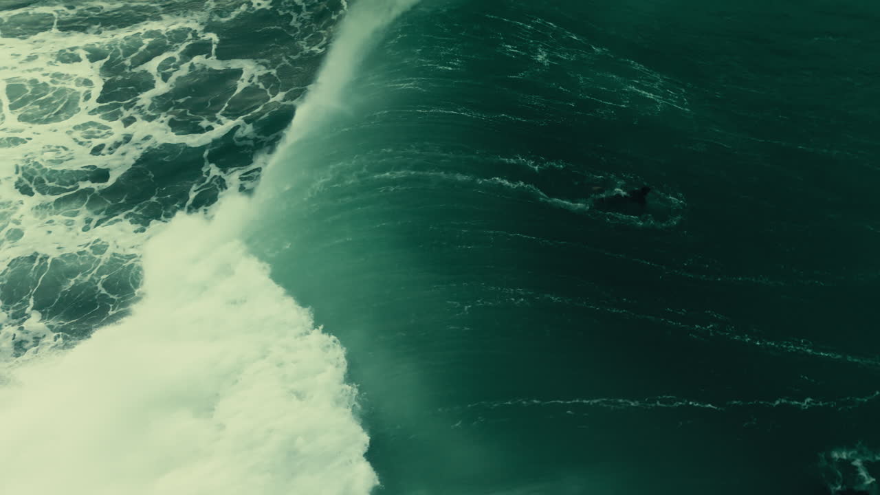 Aerial View of Surfer Riding a Massive Ocean Wave