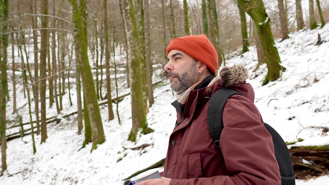 Man Drinking in Winter Forest