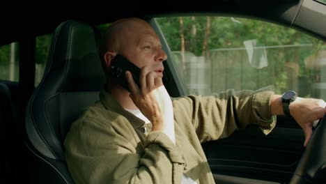 man talking on phone while driving