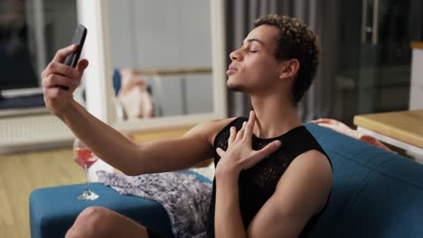 cheerful guy in dress doing selfie with mobile phone, posing
