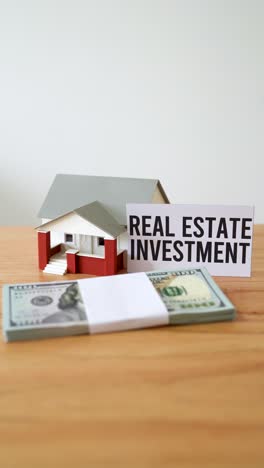 concept of investing money in real estate. vertical zoom out shot.