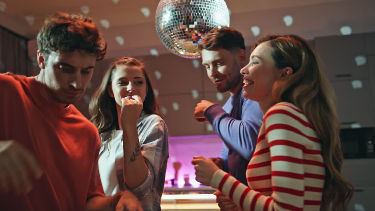 Dancing youngsters having fun at disco party home close up. Overjoyed friends