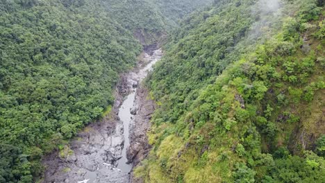 Flying-over-the-rocky-river-and-mountain-forests-of-Australia