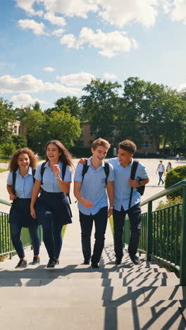 group of happy students walking on campus stairs