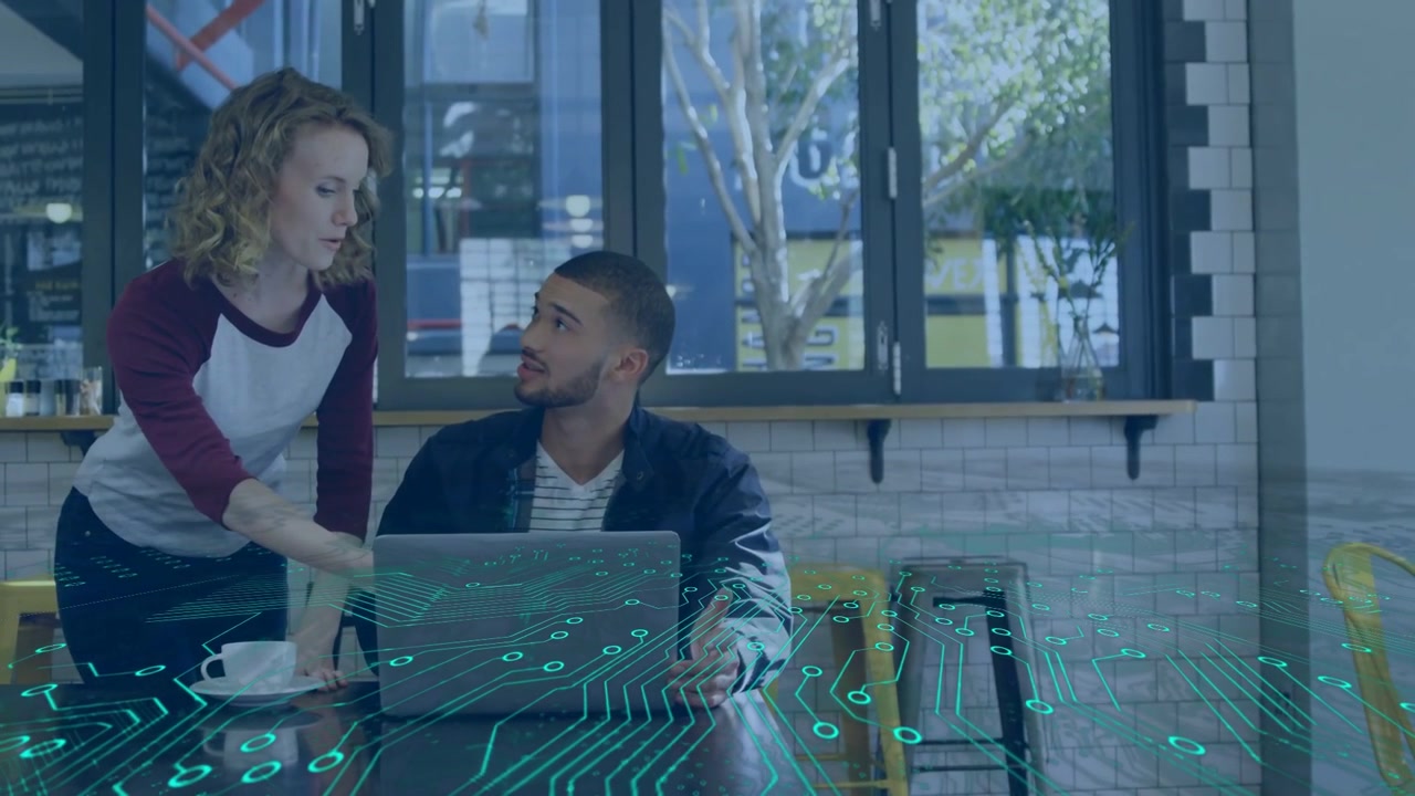 Woman placing cup pointing to laptop starting tech-collab man using it teal circuit map under hands