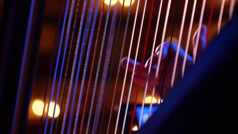 close up of harpist playing the harp with delicate fingers