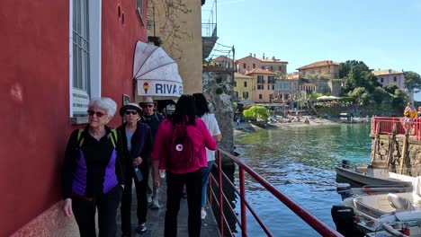 people walking by lake como in varenna