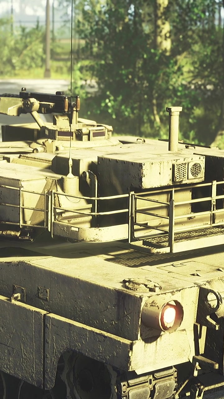 Military vehicle drives through forest area during daytime in nature setting