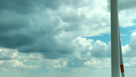 Close-up-aerial-footage-of-a-wind-turbine-blade-against-a-backdrop-of-dramatic-clouds