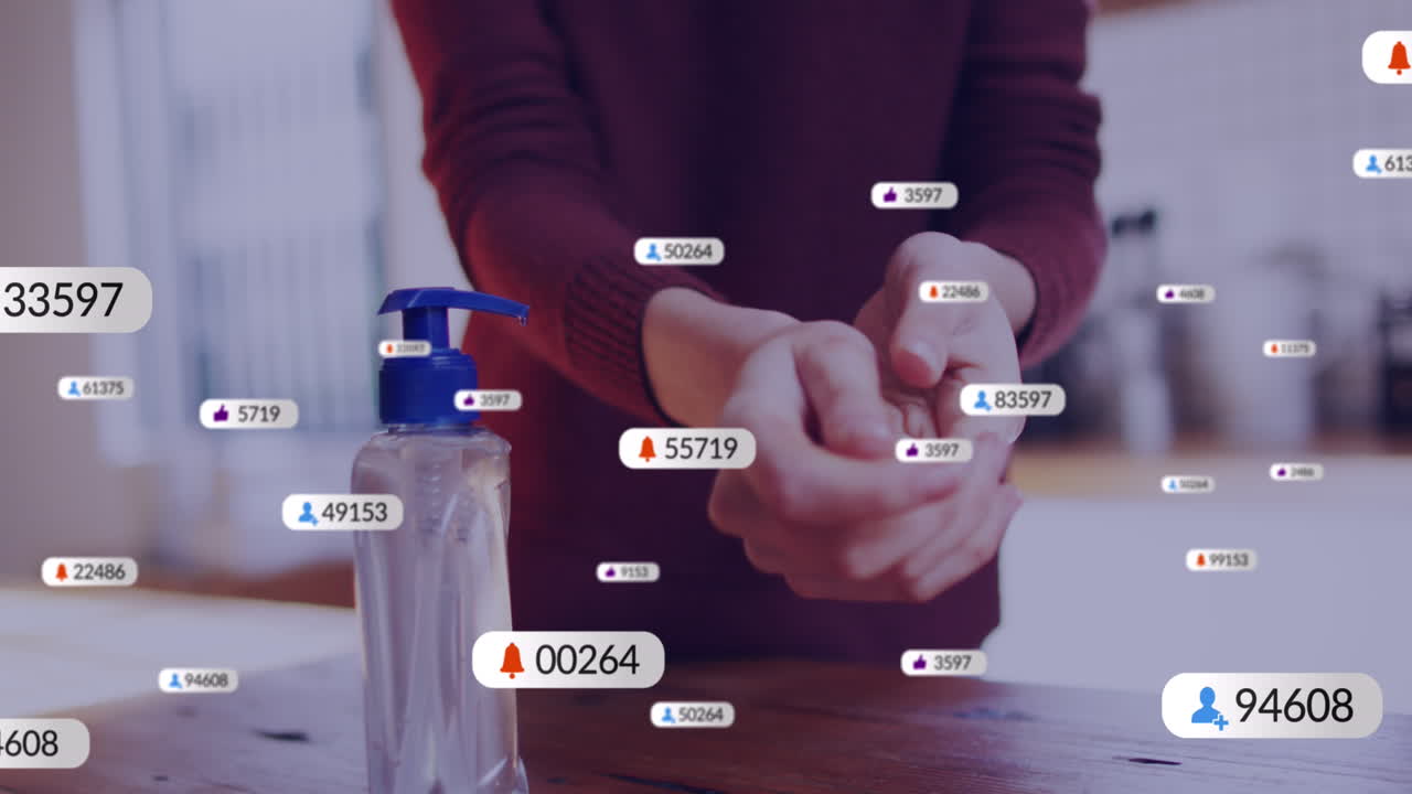 animación de iconos de redes sociales sobre la sección media de una mujer caucásica usando desinfectante de manos en casa.