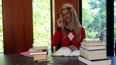 Smiling-mature-student-looking-up-from-her-book