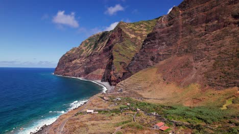 aerial view of the epic volcanic red coast of madeira on a sunny day