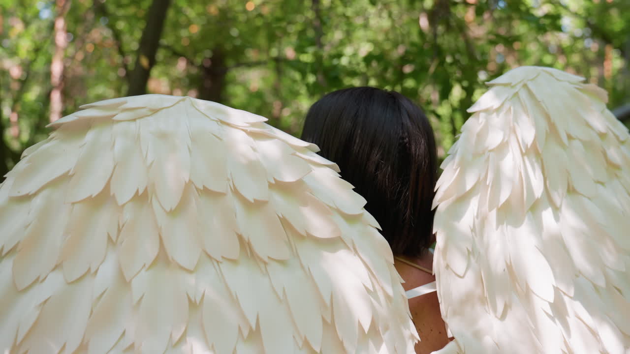 Back view of magical creature with glowing white wings surrounded by lush forest, sunlight filtering through leaves, atmosphere mystical and calm, symbolizing purity