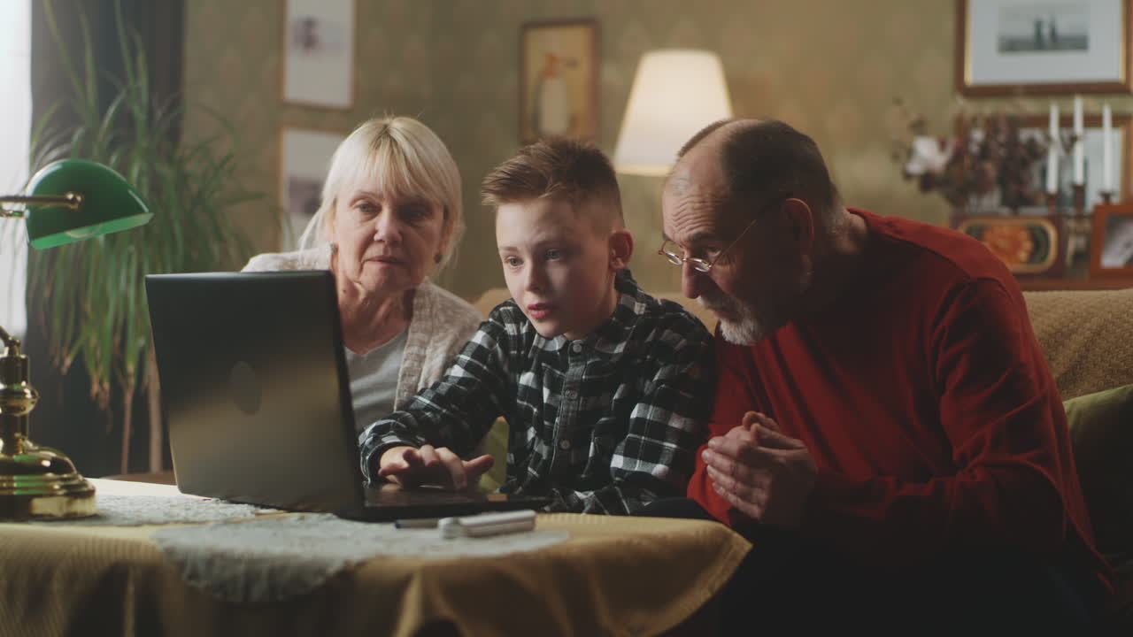 Grandparents and Grandchild Using Laptop Together