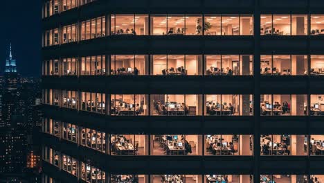 night view of a modern office building with people working late