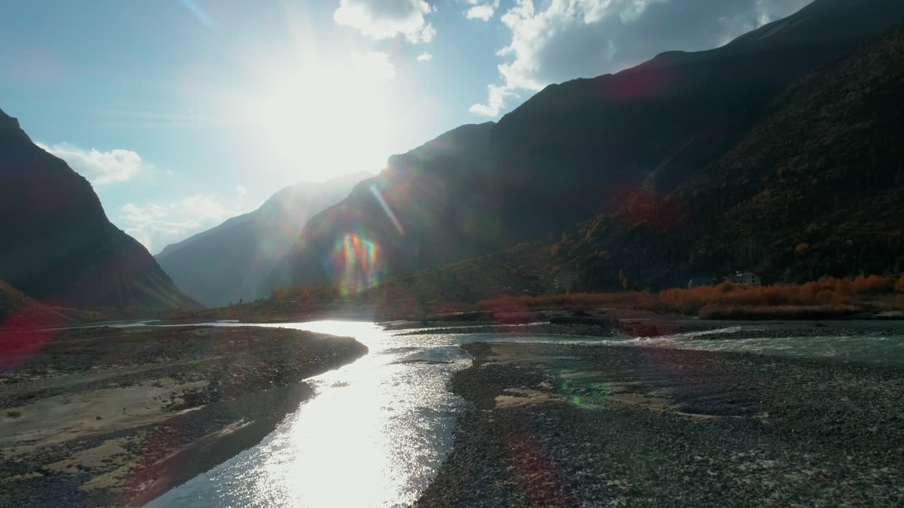 Golden hour sunlight in a dreamy autumn Himalayan mountain landscape. Glacial river stream flowing below. Spiti, Himachal, India
