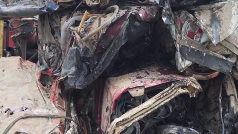 slow-motion pan of crushed cars in a junkyard