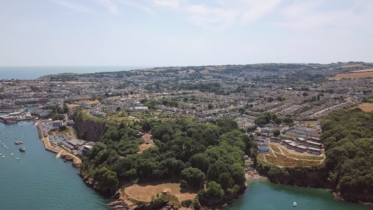 Aerial View of Coastal Town with Bay and Cliffs