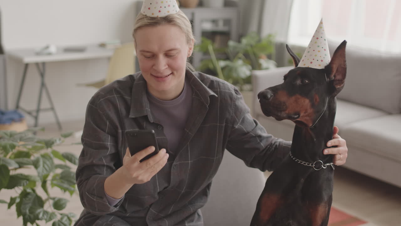 Woman and Dog Wearing Party Hats