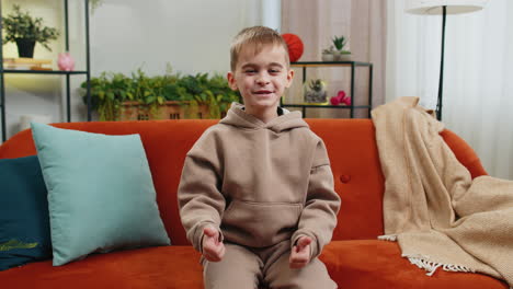 happy child kid boy looking approvingly at camera showing thumbs up like positive sign good news