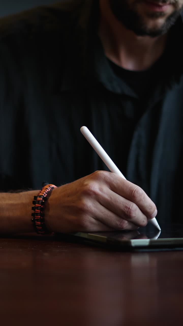 Hand using stylus on tablet