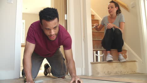 young homeowner couple decorating their house