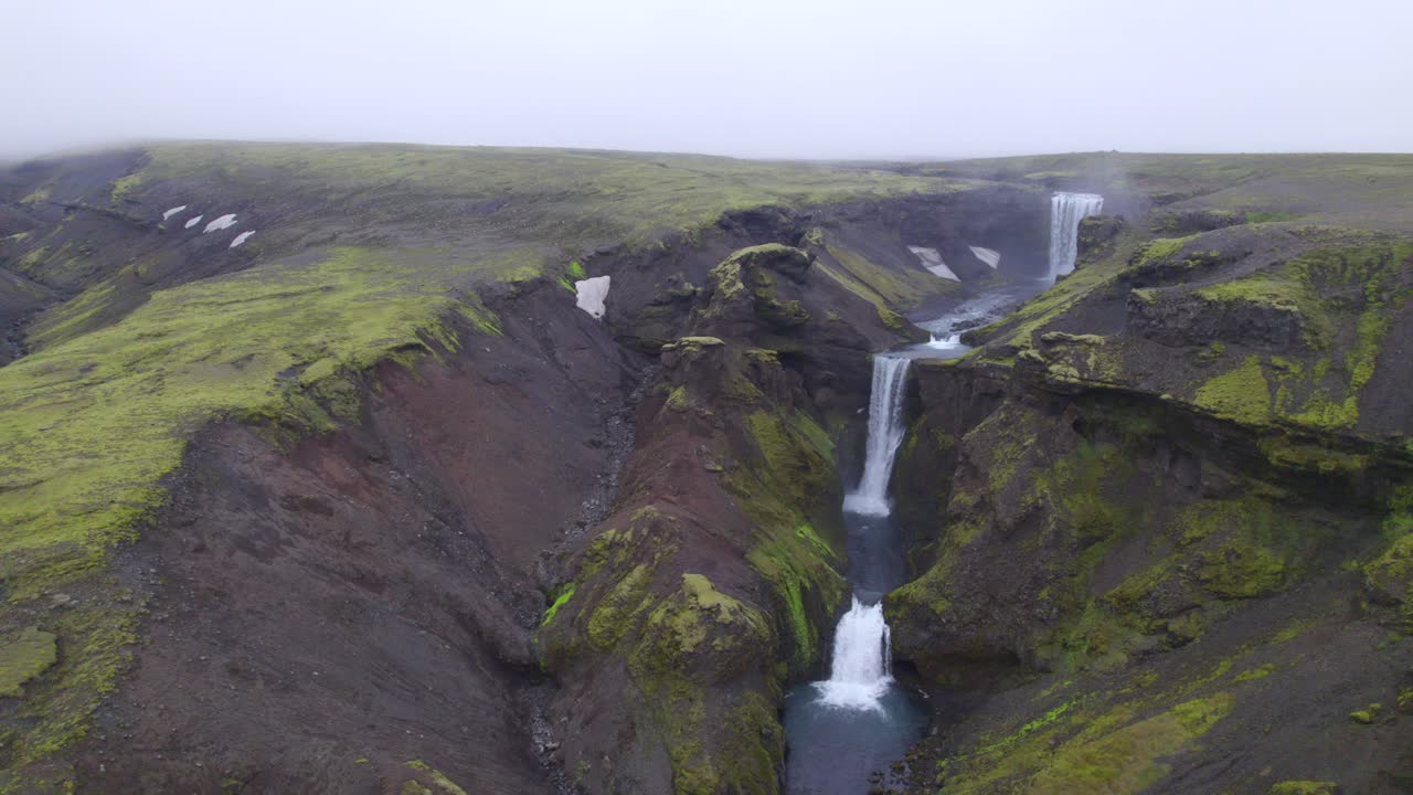 Aerial high above the famous natural landmark and tourist attraction of Skogafoss falls and Fimmvorduhals trail in Iceland